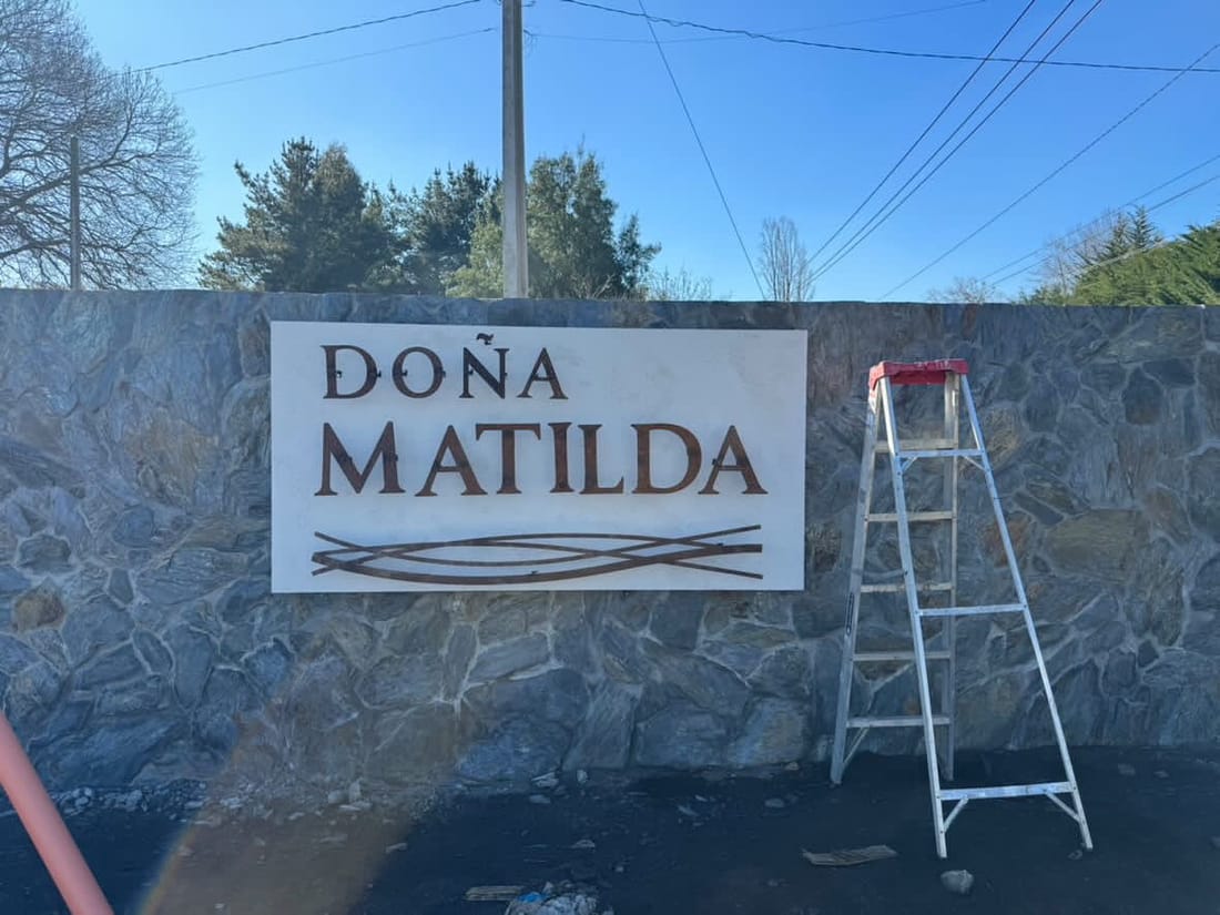 Letrero de Doña Matilda instalado sobre un muro de piedra